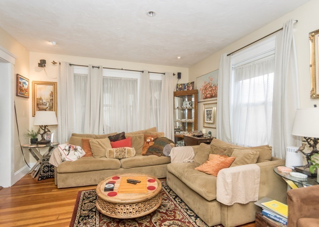 28 Bolton Street Waltham, MA 02453 - Photo 11 of 22 a living room with furniture and a large window