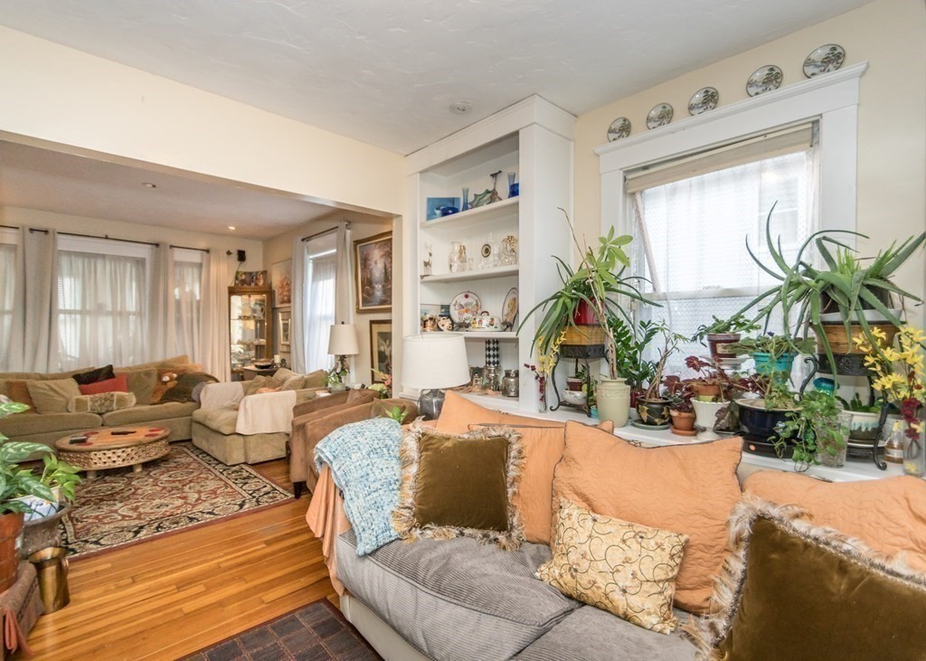 28 Bolton Street Waltham, MA 02453 - Photo 12 of 22 a living room with furniture potted plant and a window