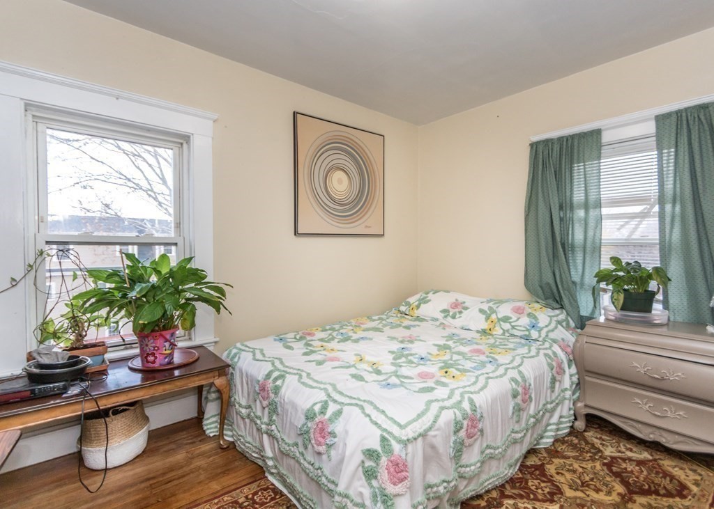 28 Bolton Street Waltham, MA 02453 - Photo 15 of 22 a bedroom that has a bed and a table in it