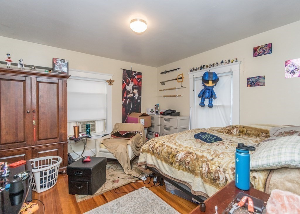 28 Bolton Street Waltham, MA 02453 - Photo 16 of 22 a bedroom with furniture and a wooden floor