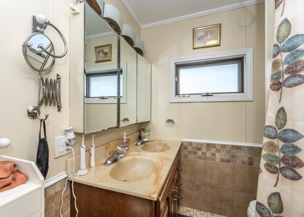 28 Bolton Street Waltham, MA 02453 - Photo 17 of 22 a bathroom with a sink and a mirror