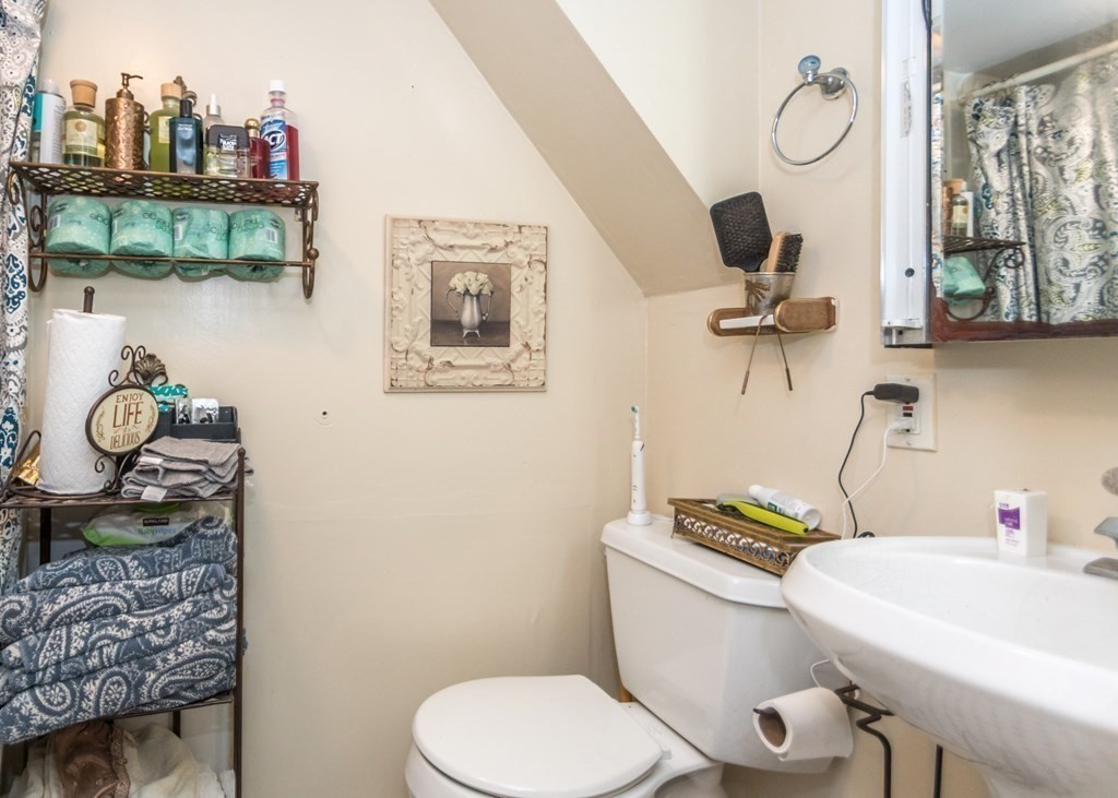 28 Bolton Street Waltham, MA 02453 - Photo 18 of 22 a bathroom with a sink mirror vanity and toilet