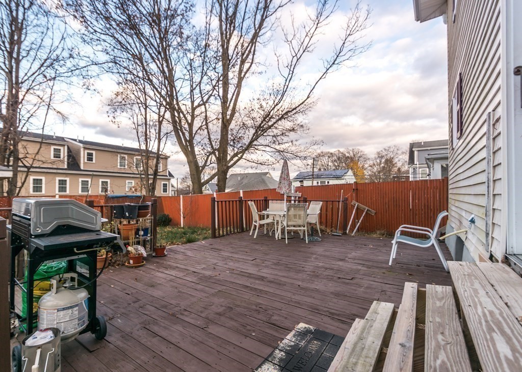 28 Bolton Street Waltham, MA 02453 - Photo 19 of 22 a view of a chairs and table on the wooden deck