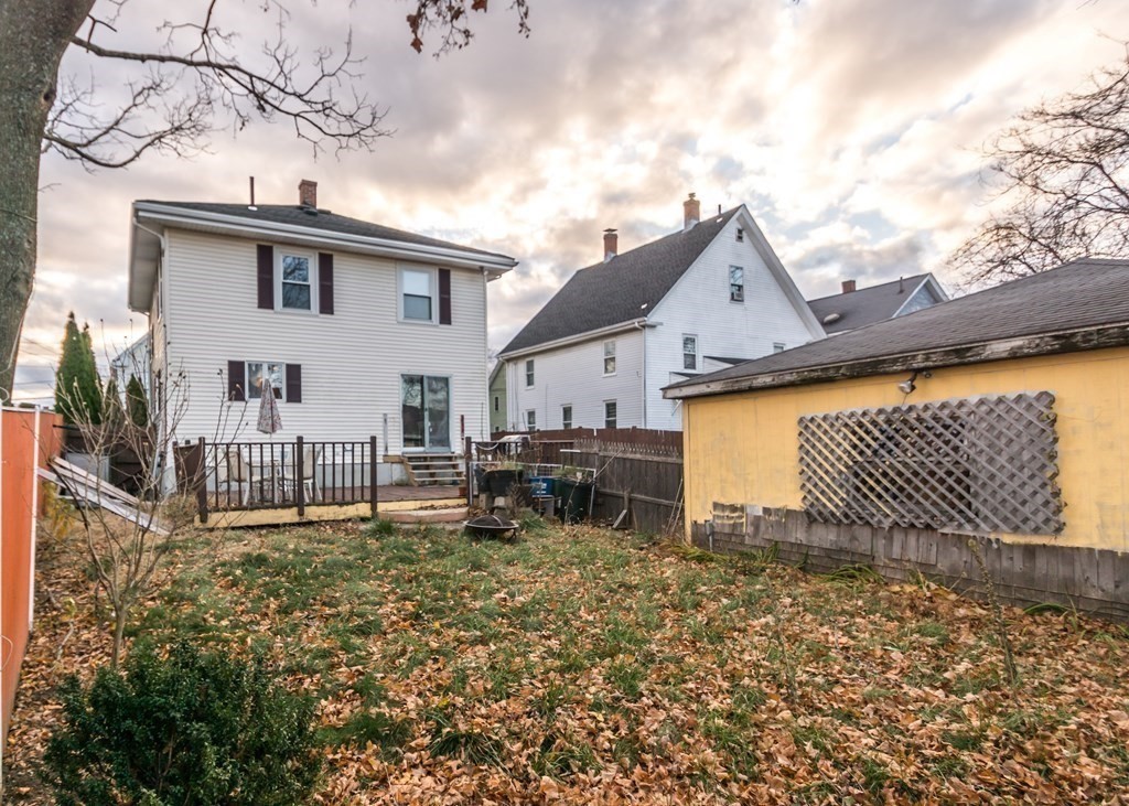 28 Bolton Street Waltham, MA 02453 - Photo 21 of 22 a backyard of a house with table and chairs