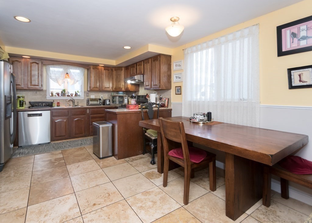 28 Bolton Street Waltham, MA 02453 - Photo 4 of 22 a kitchen with a table chairs sink and microwave