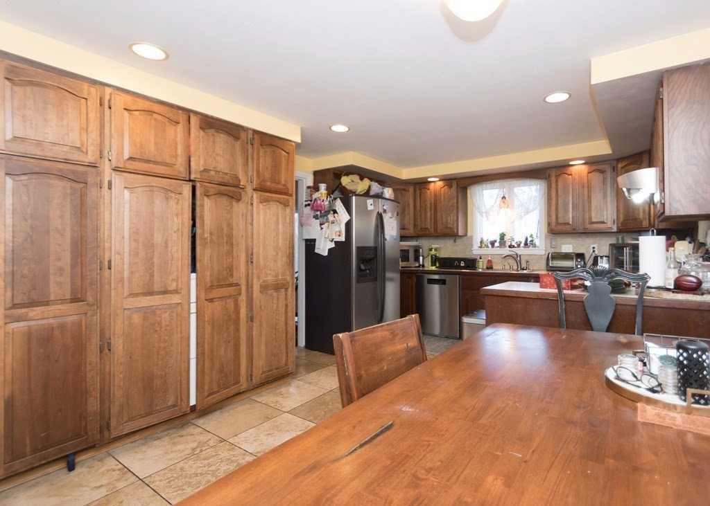 28 Bolton Street Waltham, MA 02453 - Photo 6 of 22 a living room with stainless steel appliances kitchen island granite countertop a refrigerator and a sink