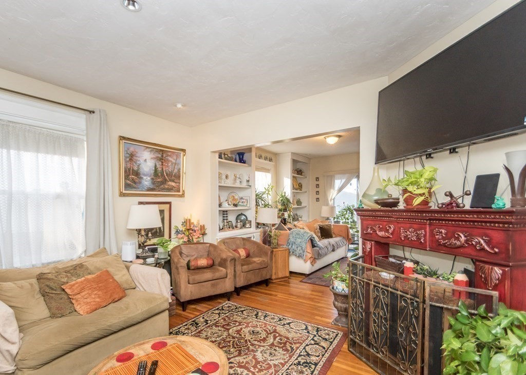 28 Bolton Street Waltham, MA 02453 - Photo 9 of 22 a living room with furniture and a flat screen tv