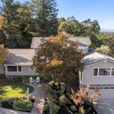 a view of house with a yard and a garden