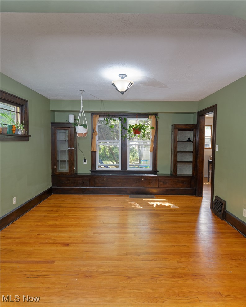 6021 Snow Road Parma, OH 44129 - Photo 5 of 28 Formal dining room with wood floors and beautiful built in cabinets