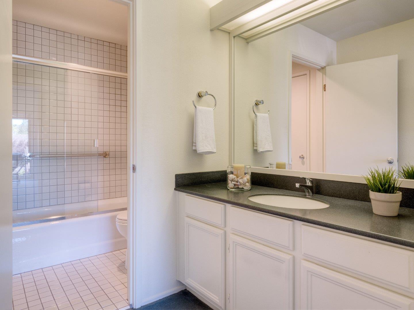 124 Peter Coutts Circle Stanford, CA 94305 - Photo 12 of 17 a bathroom with a granite countertop sink a toilet and shower