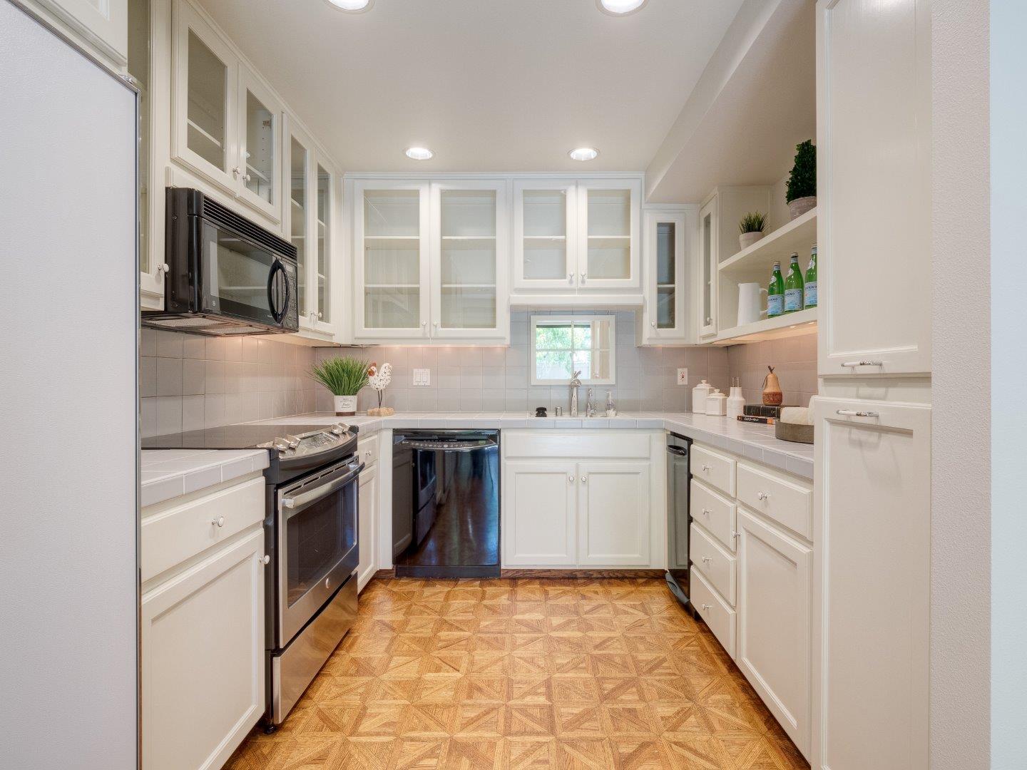 124 Peter Coutts Circle Stanford, CA 94305 - Photo 9 of 17 a kitchen with stainless steel appliances granite countertop a stove a sink and a microwave