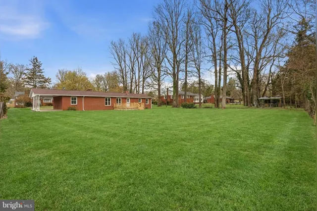 a view of a house with a yard and sitting area