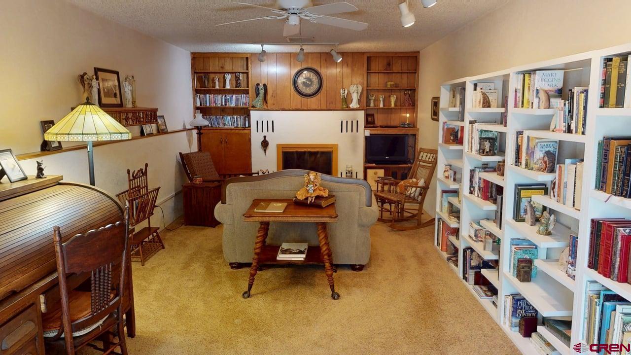96 El Rio Drive Alamosa, CO 81101 - Photo 7 of 18 a living room with furniture and a fireplace