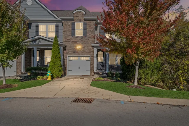 a view of a brick house with a yard