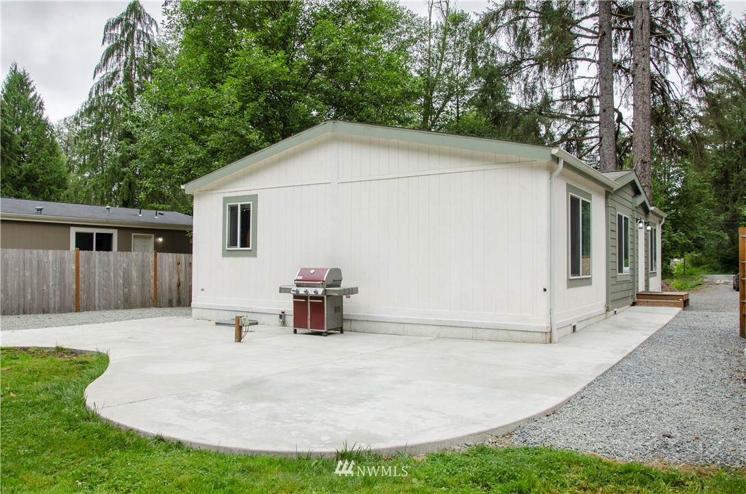6510 Skinner Road Granite Falls, WA 98252 - Photo 2 of 19 a white house with tree in front of it