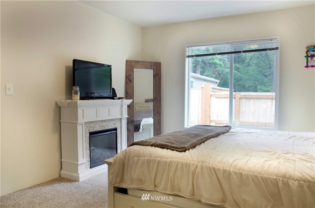 6510 Skinner Road Granite Falls, WA 98252 - Photo 13 of 19 a bedroom with a bed and a fireplace