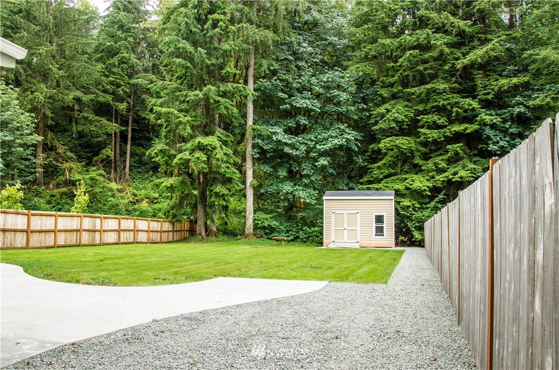6510 Skinner Road Granite Falls, WA 98252 - Photo 4 of 19 a view of a house with a small yard and large trees