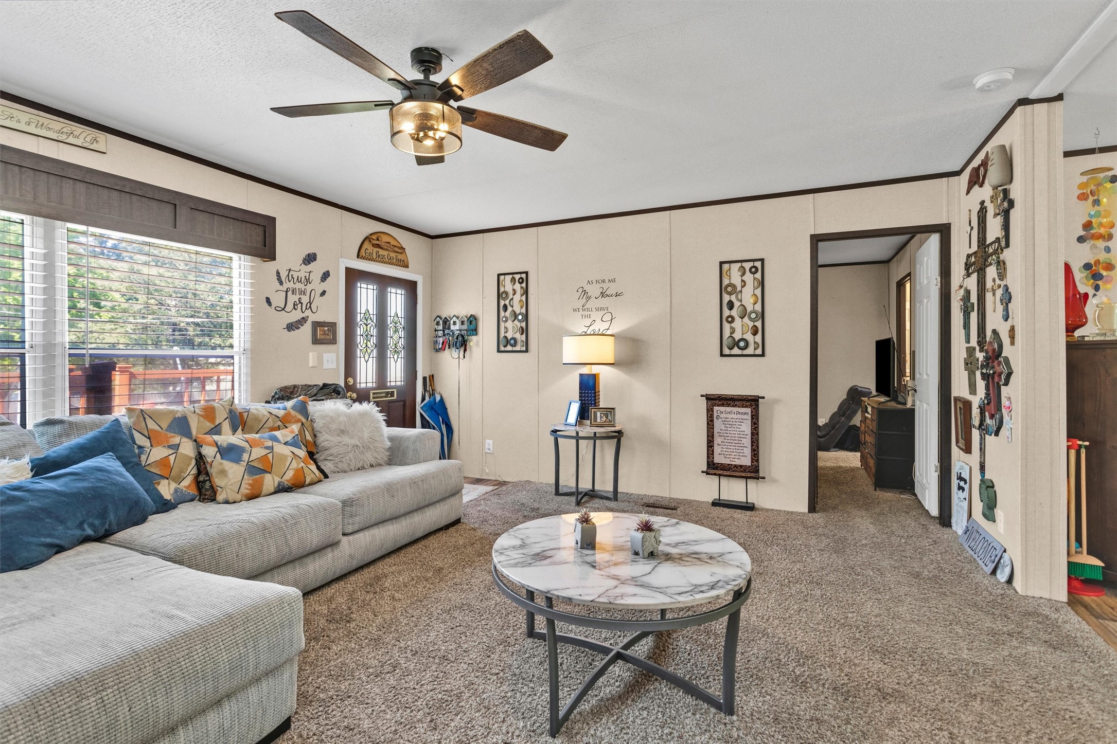 56 Michael Street Huntsville, TX 77320 - Photo 11 of 37 a living room with furniture a ceiling fan and a large window