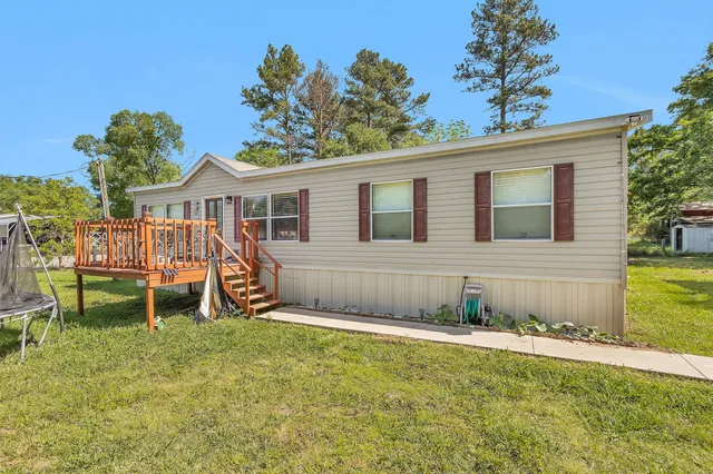 a view of a house with a yard and sitting area