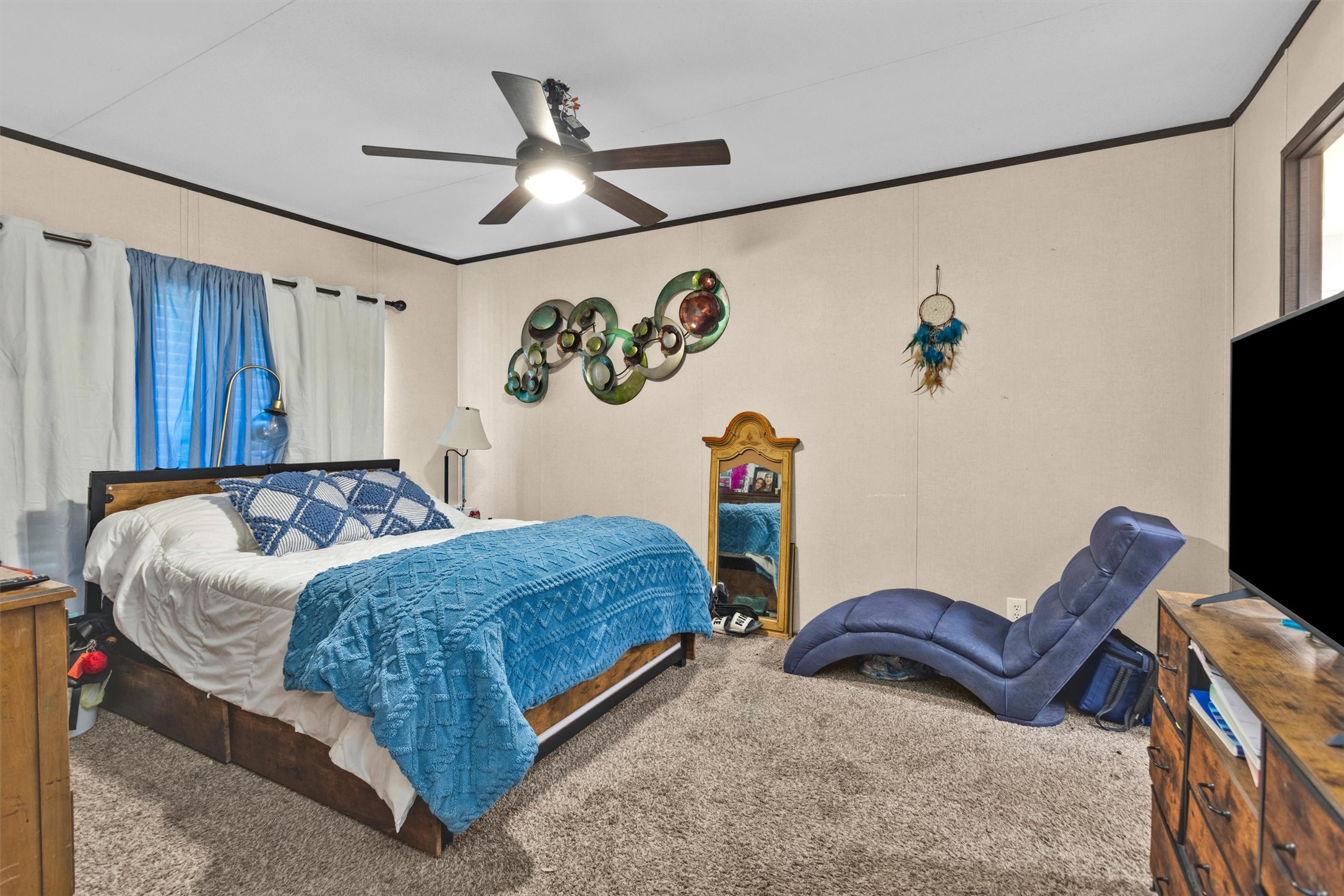 56 Michael Street Huntsville, TX 77320 - Photo 21 of 37 a bedroom with a bed and a flat screen tv