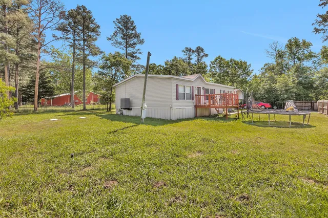 a view of a house with a big yard and sitting area