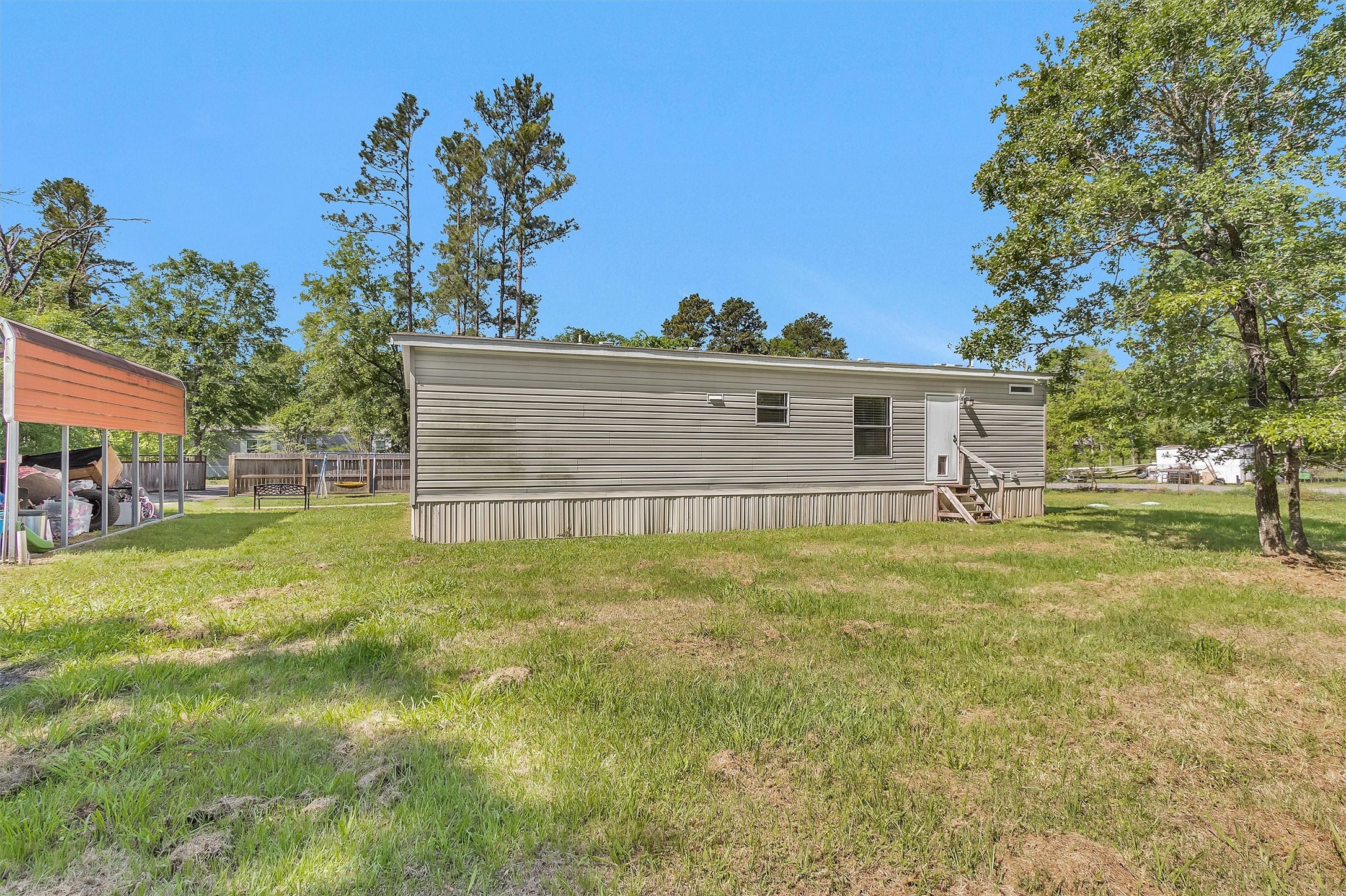 56 Michael Street Huntsville, TX 77320 - Photo 34 of 37 a view of a house with a backyard