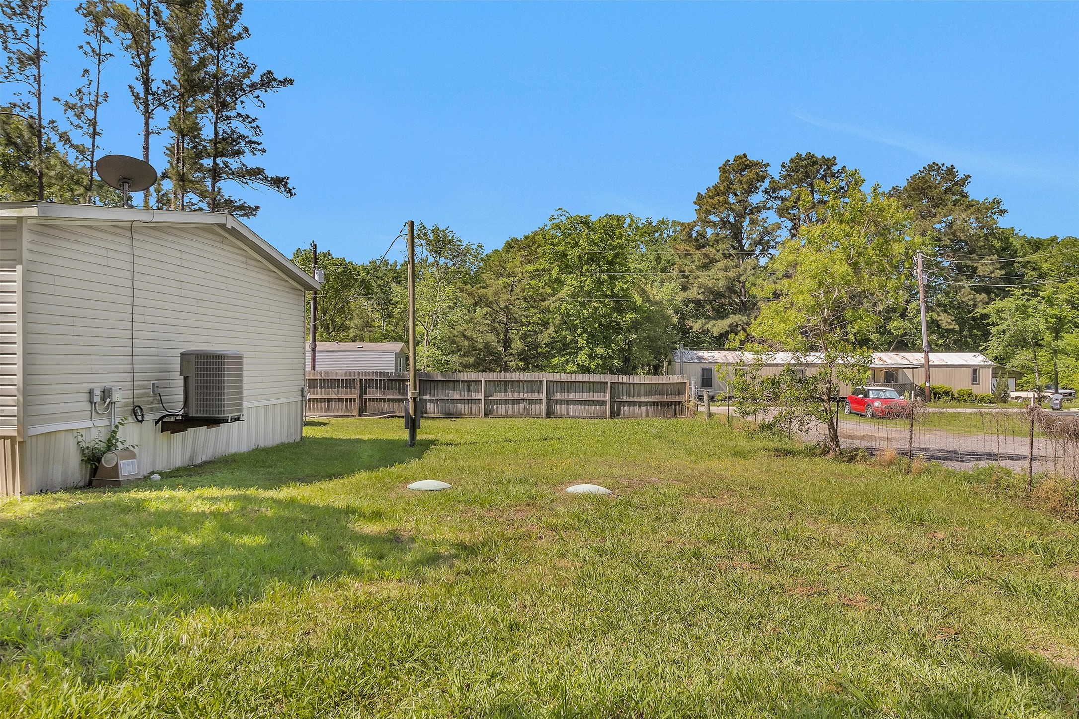 56 Michael Street Huntsville, TX 77320 - Photo 36 of 37 a view of a backyard with couches plants and large tree