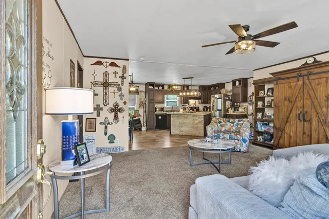 a living room with fireplace furniture and a rug