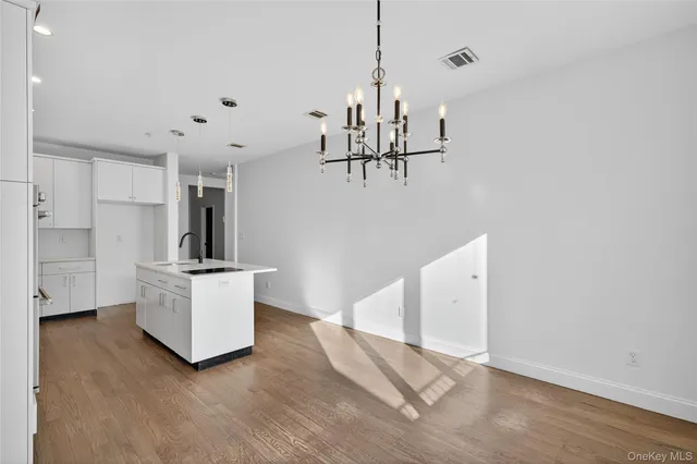 a view of kitchen and white refrigerator