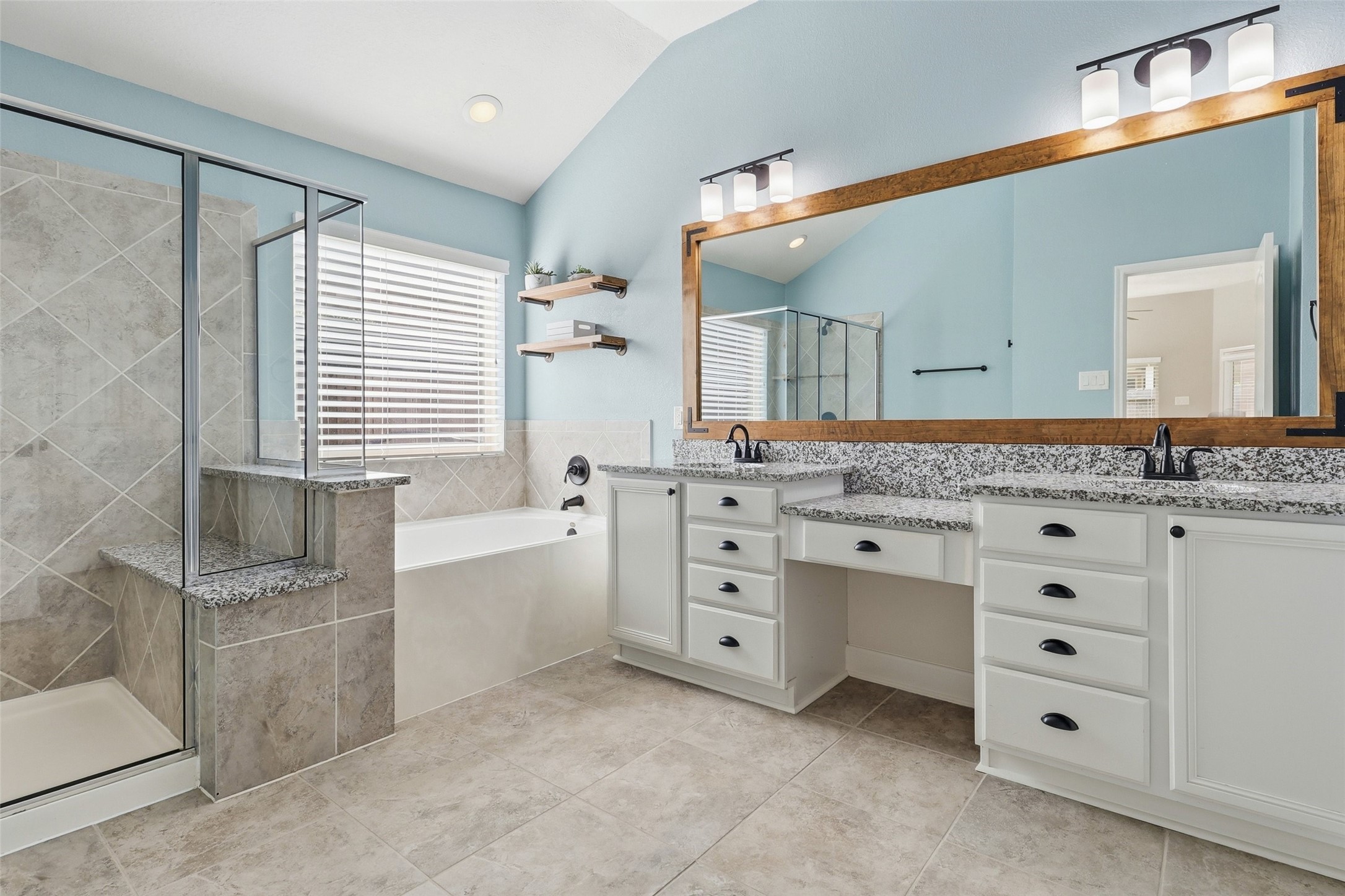 24126 Cane Fields Road Katy, TX 77493 - Photo 27 of 36 Spa-inspired primary bath featuring dual vanities, a soaking tub, and separate shower