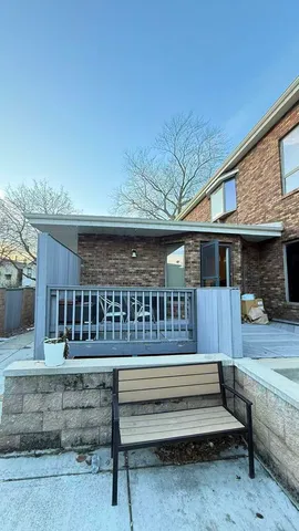 a view of wooden door and outdoor seating