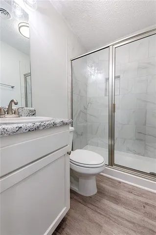 a bathroom with a toilet sink and a shower