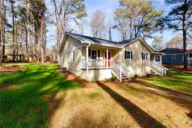 a front view of a house with a yard table and chairs