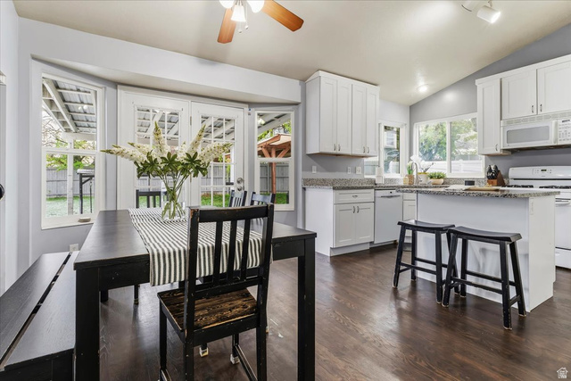 7975 Showcase Lane Sandy, UT 84094 - Photo 7 of 29 New white shaker kitchen with granite island, dark wood floors and vaulted ceiling.