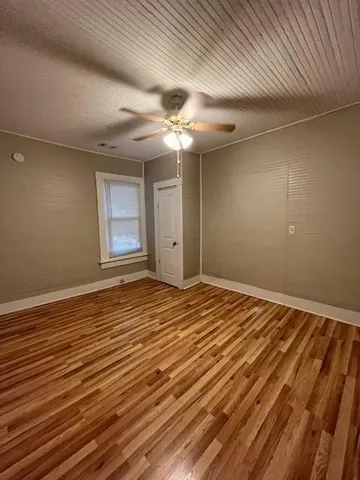 a view of a room with wooden floor