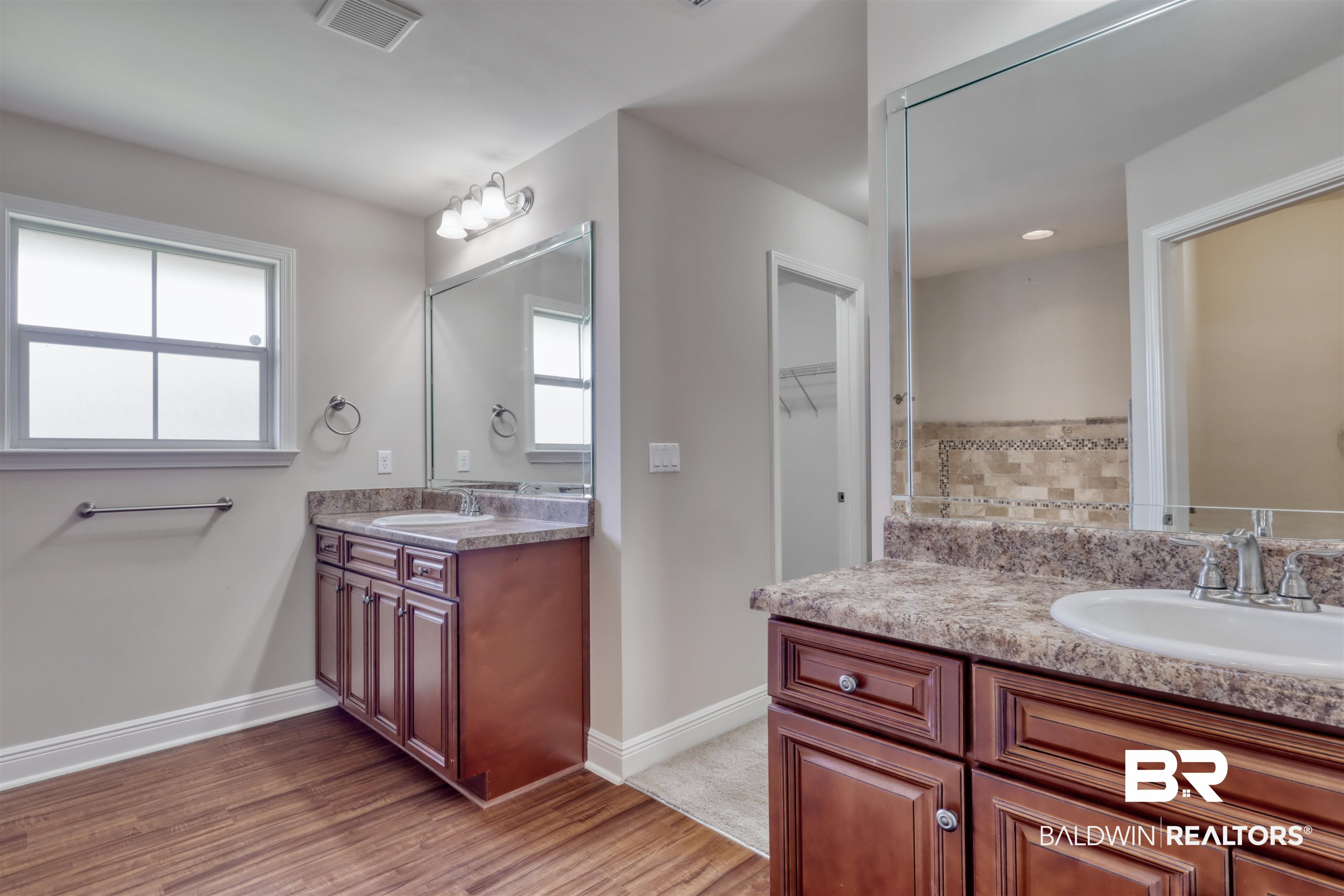 14794 Troon Drive Foley, AL 36535 - Photo 17 of 33 Full bath with visible vents, a sink, wood finished floors, and two vanities