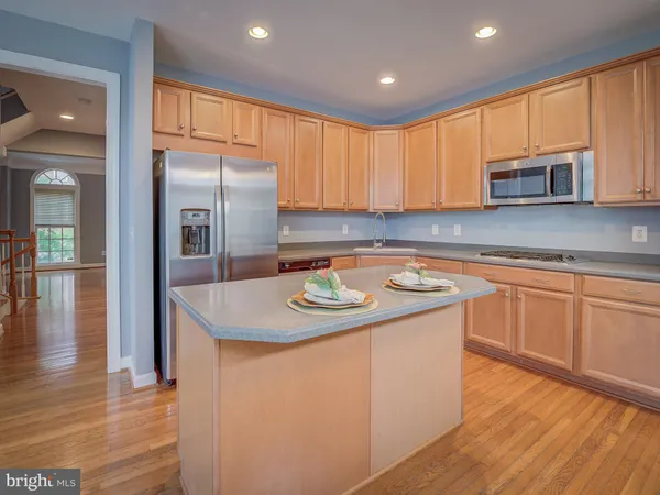 a kitchen with a stove a sink a dining table and chairs