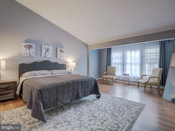 a bedroom with a bed and a couch