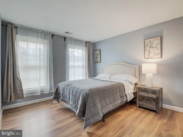 a view of a room with a window and wooden floor