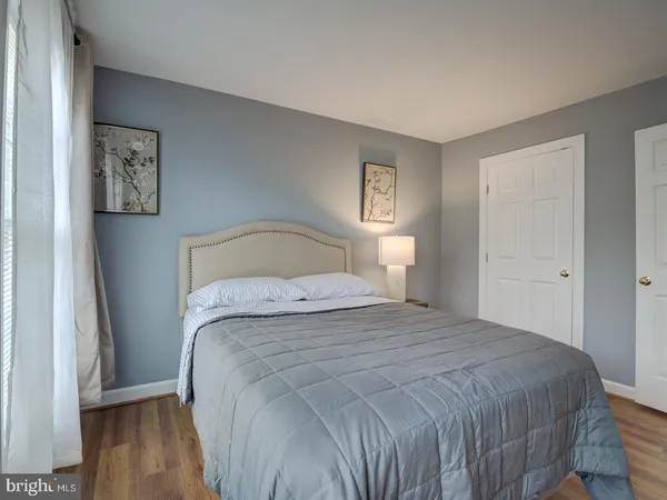 a bedroom with a large bed and a lamp