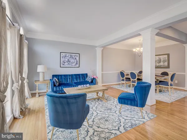a living room with furniture a lamp and a window