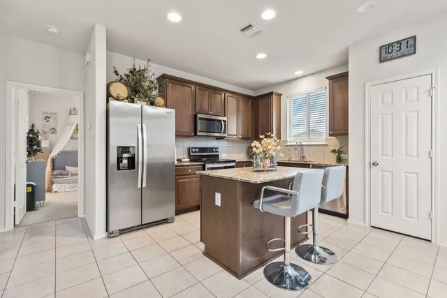 a kitchen with stainless steel appliances granite countertop a sink and a stove
