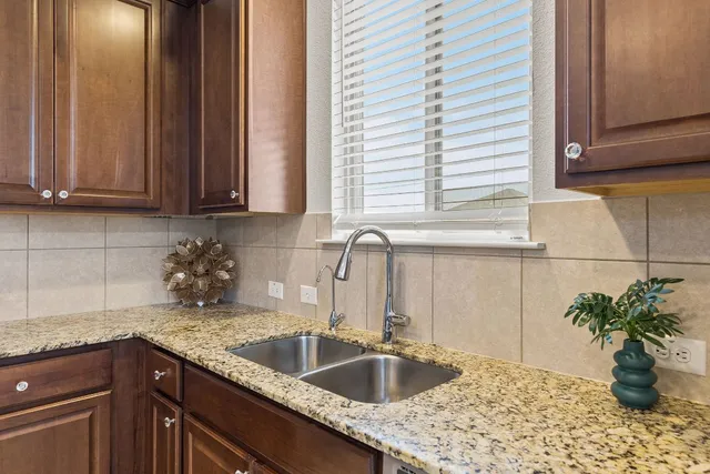 a kitchen with stainless steel appliances a refrigerator sink and cabinets