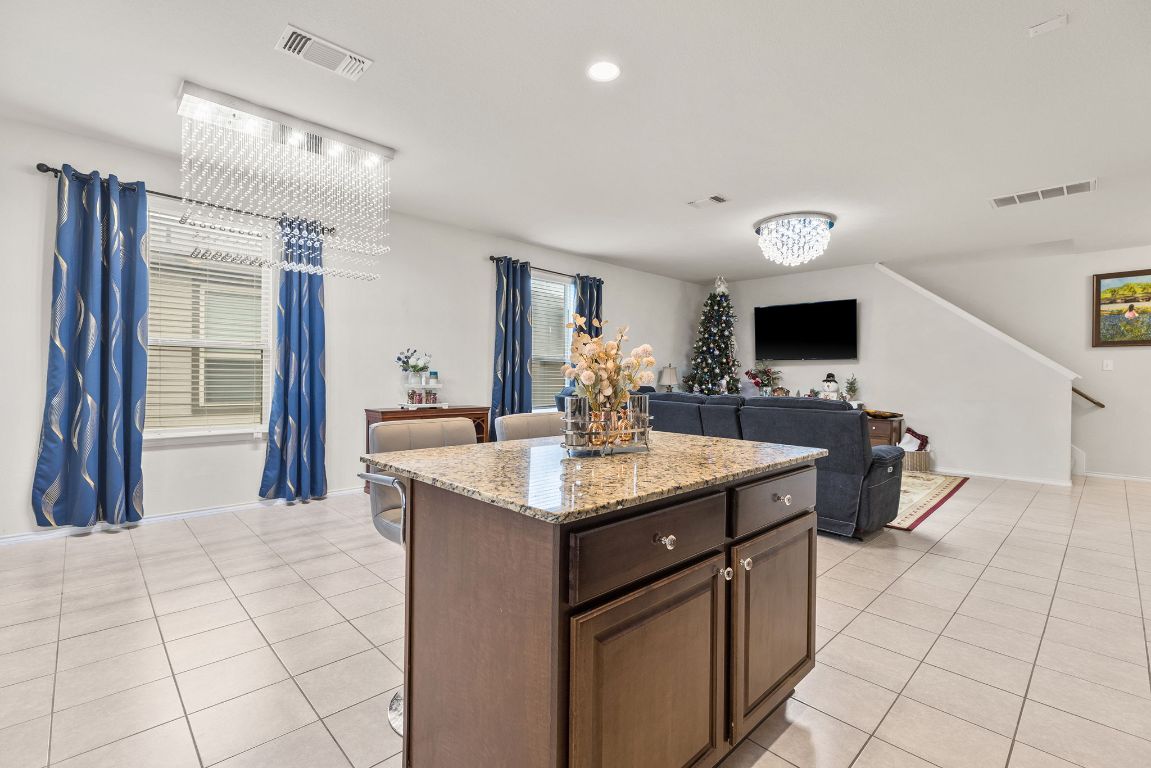 209 Ibis Falls Loop Jarrell, TX 76537 - Photo 15 of 40 a kitchen with stainless steel appliances granite countertop a sink and a stove