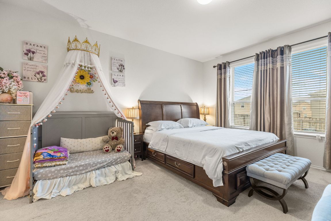 209 Ibis Falls Loop Jarrell, TX 76537 - Photo 20 of 40 a bedroom with a bed and a couch