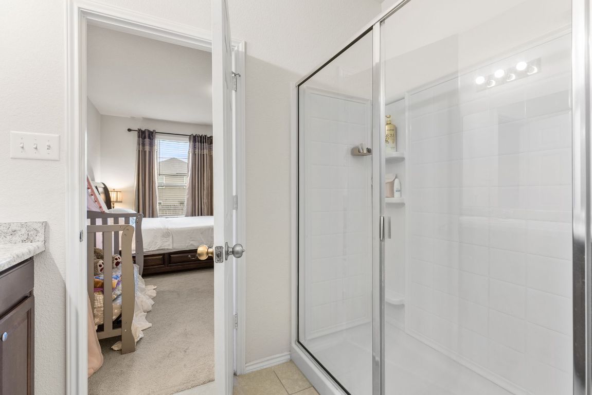 209 Ibis Falls Loop Jarrell, TX 76537 - Photo 22 of 40 a en suite bathroom with a shower