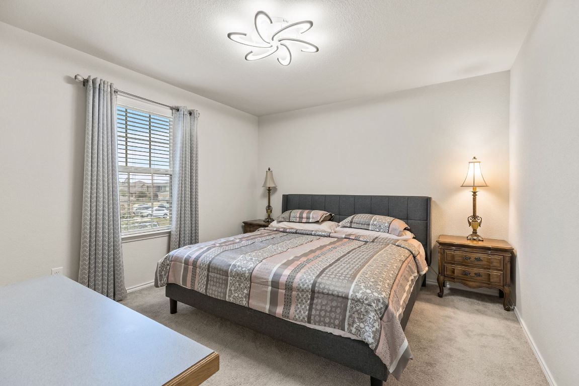 209 Ibis Falls Loop Jarrell, TX 76537 - Photo 26 of 40 a bedroom with a bed and window