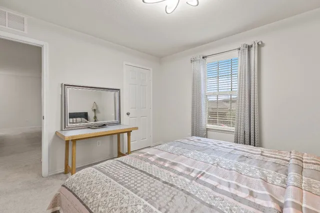 a bathroom with a granite countertop sink toilet a mirror a vanity and shower