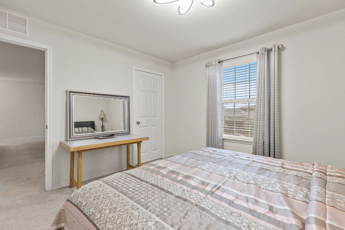 209 Ibis Falls Loop Jarrell, TX 76537 - Photo 27 of 40 a bedroom with a bed and a dresser