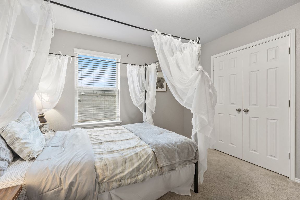 209 Ibis Falls Loop Jarrell, TX 76537 - Photo 31 of 40 a bedroom with a bed and a window